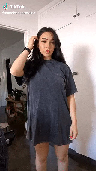 Leah Wilde shows off her hourglass figure as she tightens her oversized t-shirt (& my pants)'